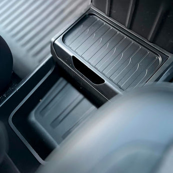 Tesla Model Y Standard under console storage tray for easy access to phone and keys while driving