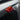 Close-up view of red glossy Carbon Fiber Turn Signal Stalk Covers intalled on Tesla Model Y Juniper