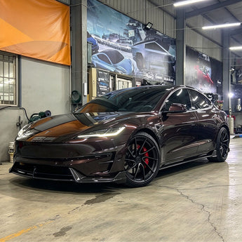 Installed carbon fiber front lip splitter on a dark-colored Tesla Model 3 Highland Performance