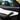 Close-up of carbon fiber weave texture on Tesla Model Y Juniper door trim with integrated blue ambient lighting