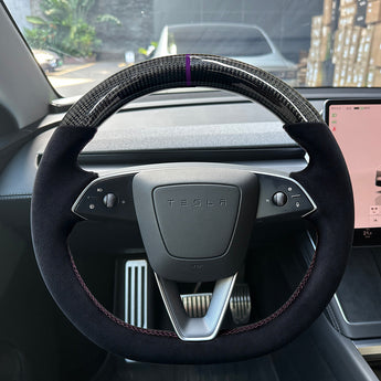 Real carbon fiber and suede racing steering wheel with purple center marker installed in Tesla Model Y Juniper interior