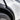 Close-up of glossy black ABS wheel arch trim fitted around the Tesla Model Y Juniper front wheel