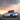 Rear three-quarter driving view of Tesla Model Y Juniper with rear diffuser and spoiler body kit