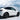 Side view of white Tesla Model Y Juniper with black wheel arch trim on front and rear fenders