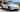 White Tesla Model Y L parked outdoors in Australian summer sunlight