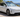 White Tesla Model Y L parked outdoors in Australian summer sunlight