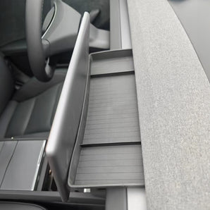 Center dashboard storage tray, light gray with ribbed texture and open front compartment