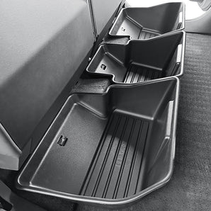 Underseat storage bin with multiple compartments and ribbed insert, dark gray.