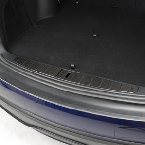 Installed carbon fiber trunk sill protector with dark weave and rectangular cutout