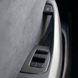 Carbon fiber window switch trim cover with textured trim and surrounding panel