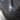 Blue aluminum tire valve stem cap installed on a Tesla wheel.