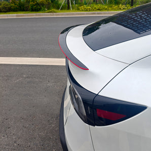 Close-up of real red carbon fiber weave on Model Y Juniper spoiler