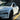 Front quarter view of a white Tesla Model Y Juniper with an installed bull-horn carbon fiber mirror cover