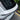 Top-down view of a matte dry carbon fiber rear spoiler showing its woven texture and fit along the rear liftgate of a Tesla Model Y Juniper.