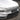 Close-up of Dragon Flame Pro front lip and splitter installed on Tesla Model Y Juniper