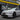 Rear three-quarter view of white Tesla Model Y Juniper with REV body kit