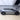 Full side profile of silver Tesla Model Y Juniper fitted with black front and rear wheel arch trims
